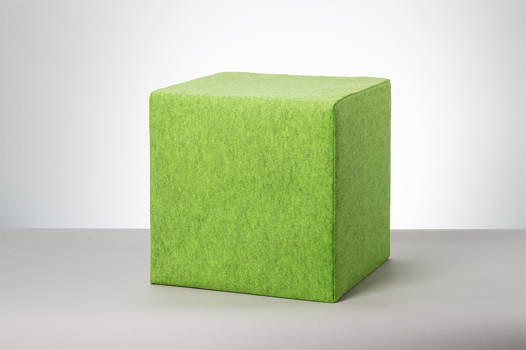 Green seating cube photographed against a white background.
