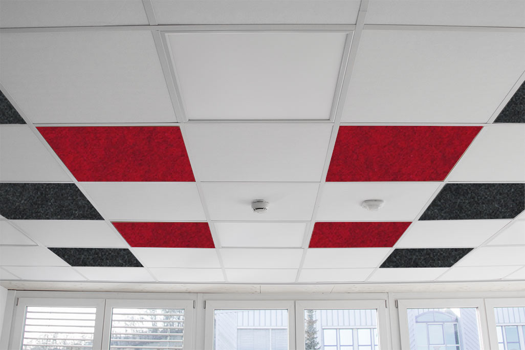 Grid ceiling in an office with square, colored inlaid acoustic elements in white, red and anthracite.